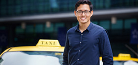 Young Man Standing In Front Of Taxi Cab